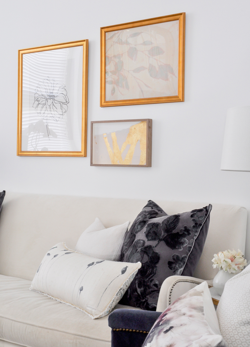 navy and white pillows in gold and white glam living room