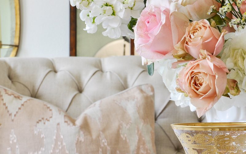 spring dining room with paste flowers and white tufted settee