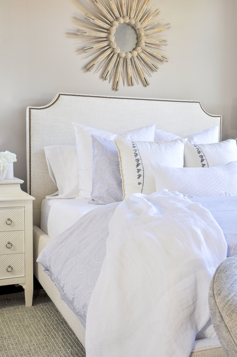 beautiful layered bed with white bedding and white sheets