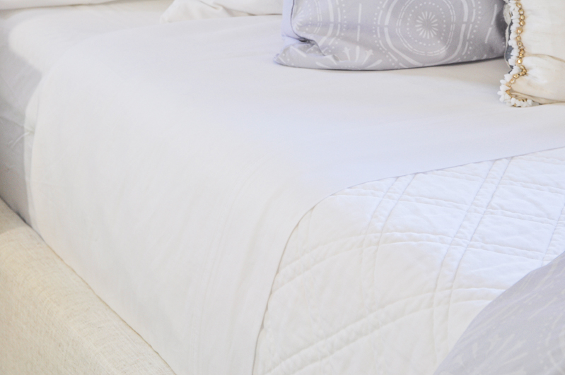 beautiful white bedding and coverlet