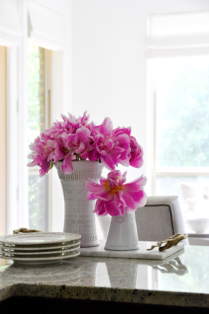 White vase bright pink peonies