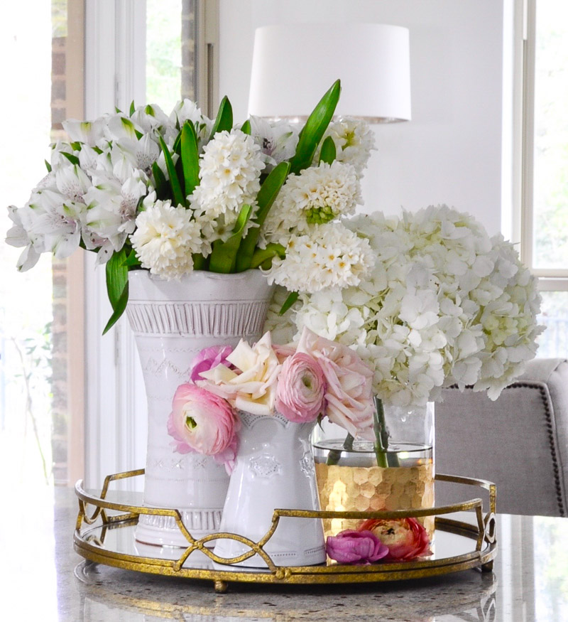 Beautiful round gold tray holding vases 