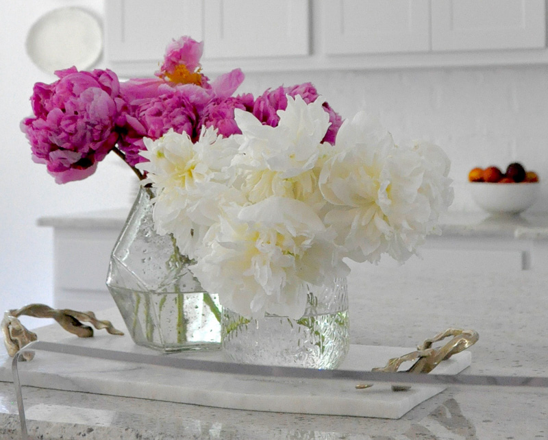 Marble cheese board holds vases