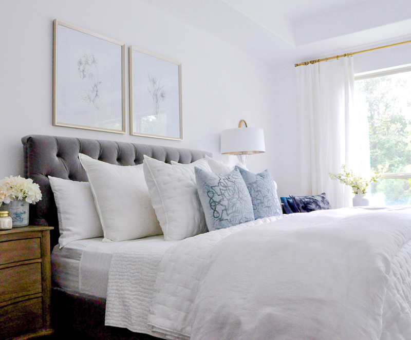 bedroom gray bed white bedding blue accents