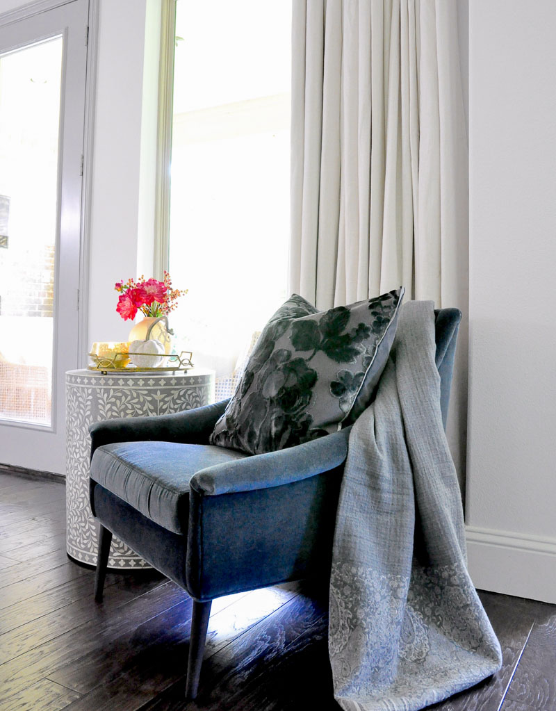 Blue velvet chair gray throw blanket 