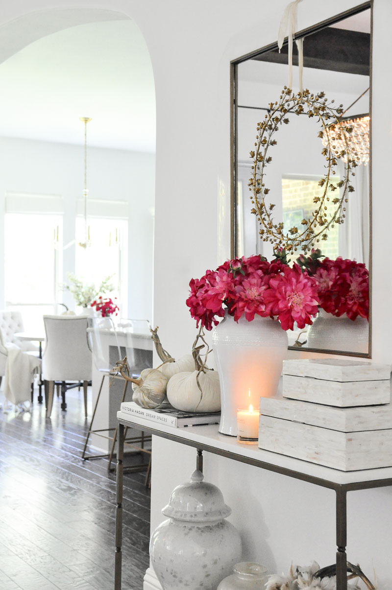 Console table pink fall flowers white velvet pumpkins