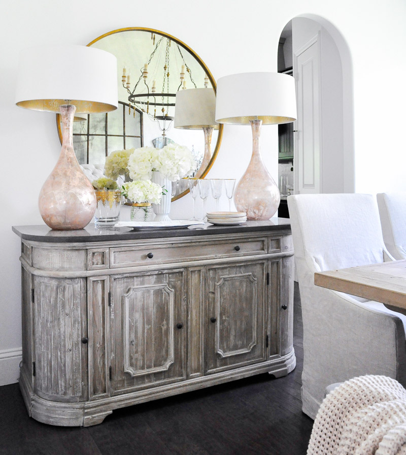 Dining room sideboard round mirror blush pink lamps