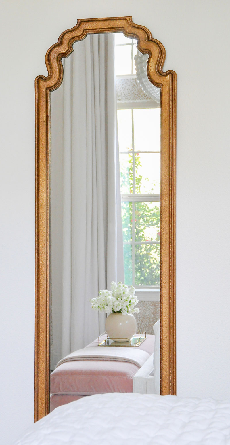 Gold framed guest bedroom mirror