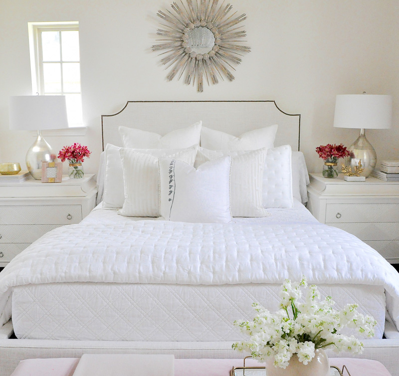 Starburst mirror above bed guest bedroom