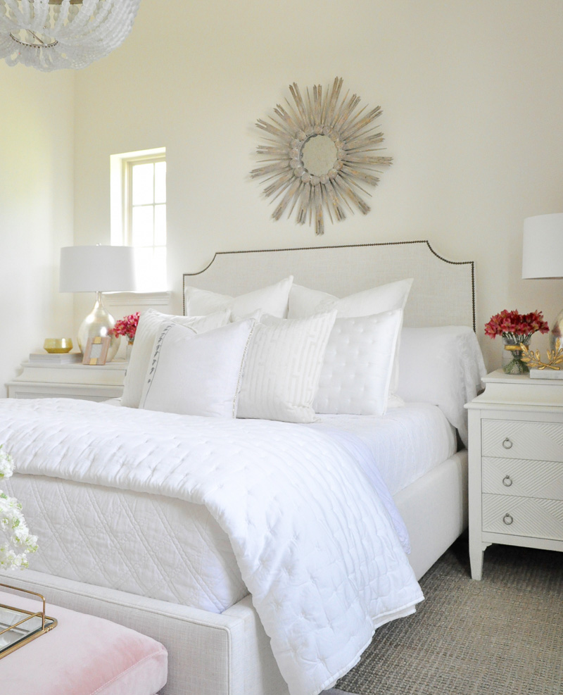 Beautiful white guest room starburst mirror 