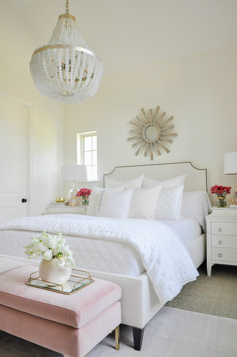 Beautiful white guest bedroom starburst mirror beaded chandelier