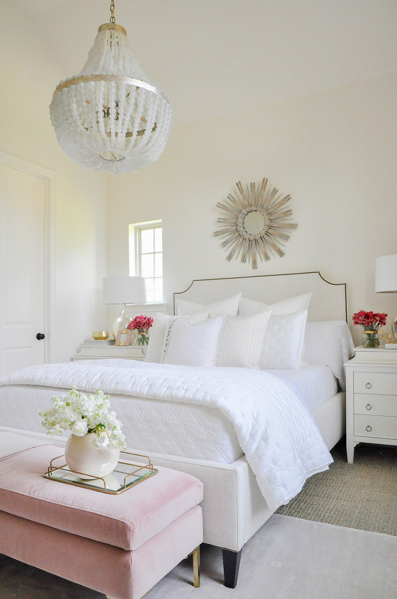 Beautiful white guest bedroom blush accents