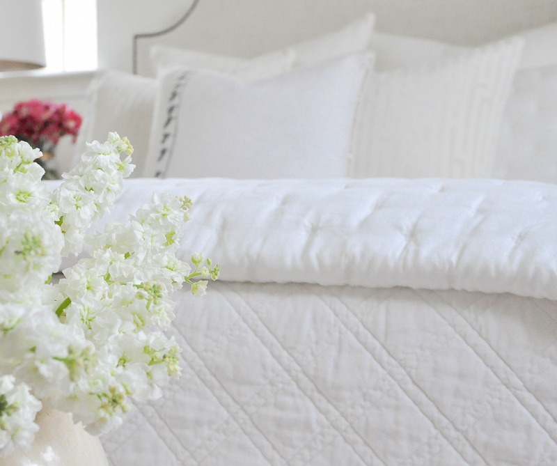 Beautiful cozy white bedding guest room