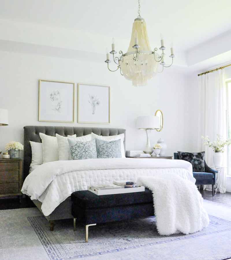 Master bedroom gray tufted bed white bedding 