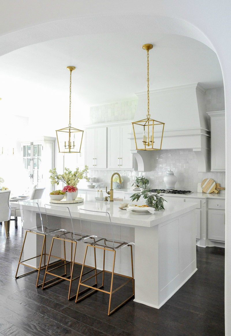 White kitchen large vent hood tile backsplash full wall 