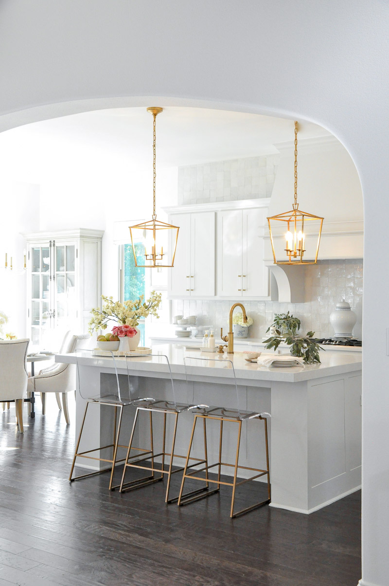 Stunning white kitchen gold lights clear stools 