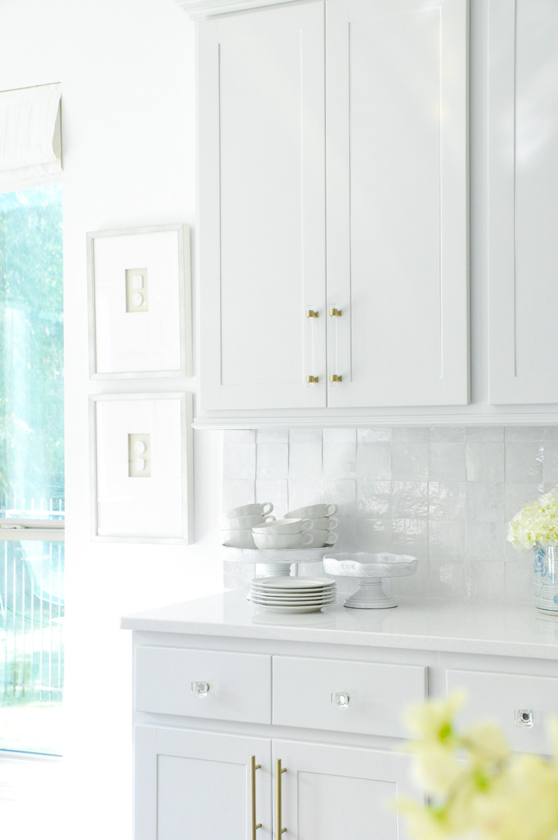 Light gray kitchen cabinets brass pulls 