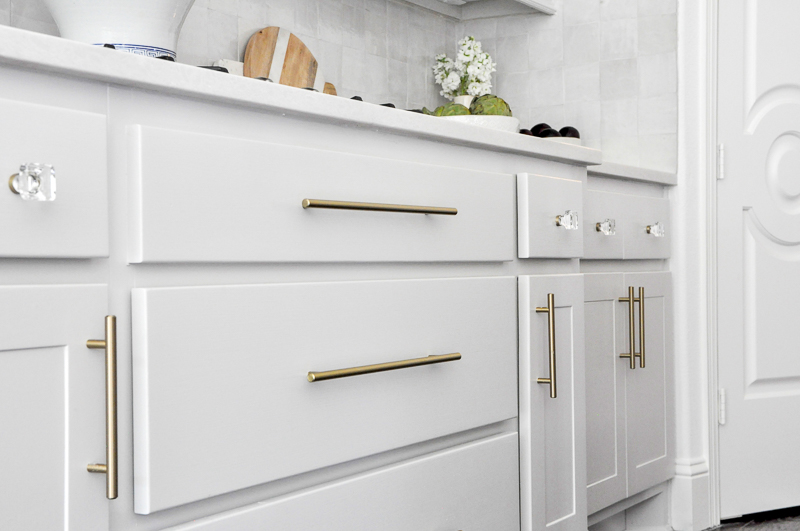 Light gray kitchen lower cabinets brass pulls Beautiful transitional design