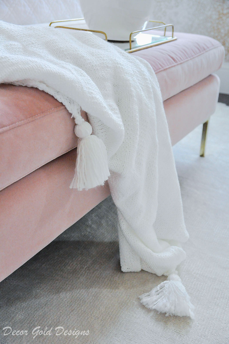 white tassel throw blanket pink bench