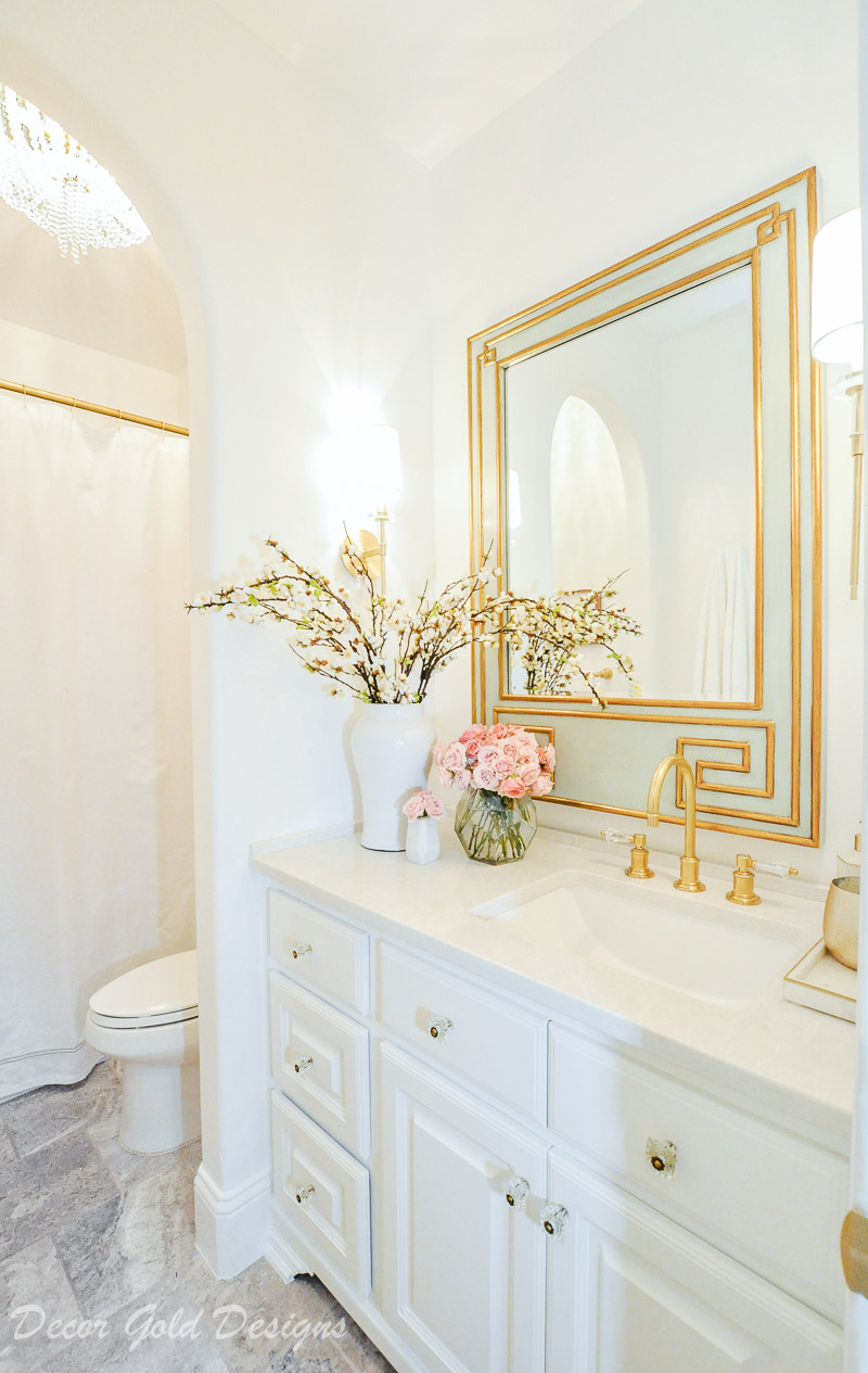 Beautiful powder bathroom bright white walls vanity brass accents