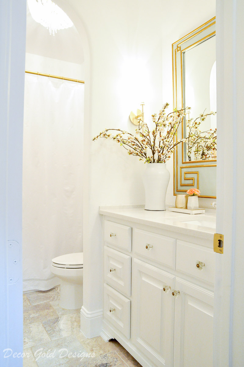 Beautiful powder bathroom bright white walls vanity brass accents