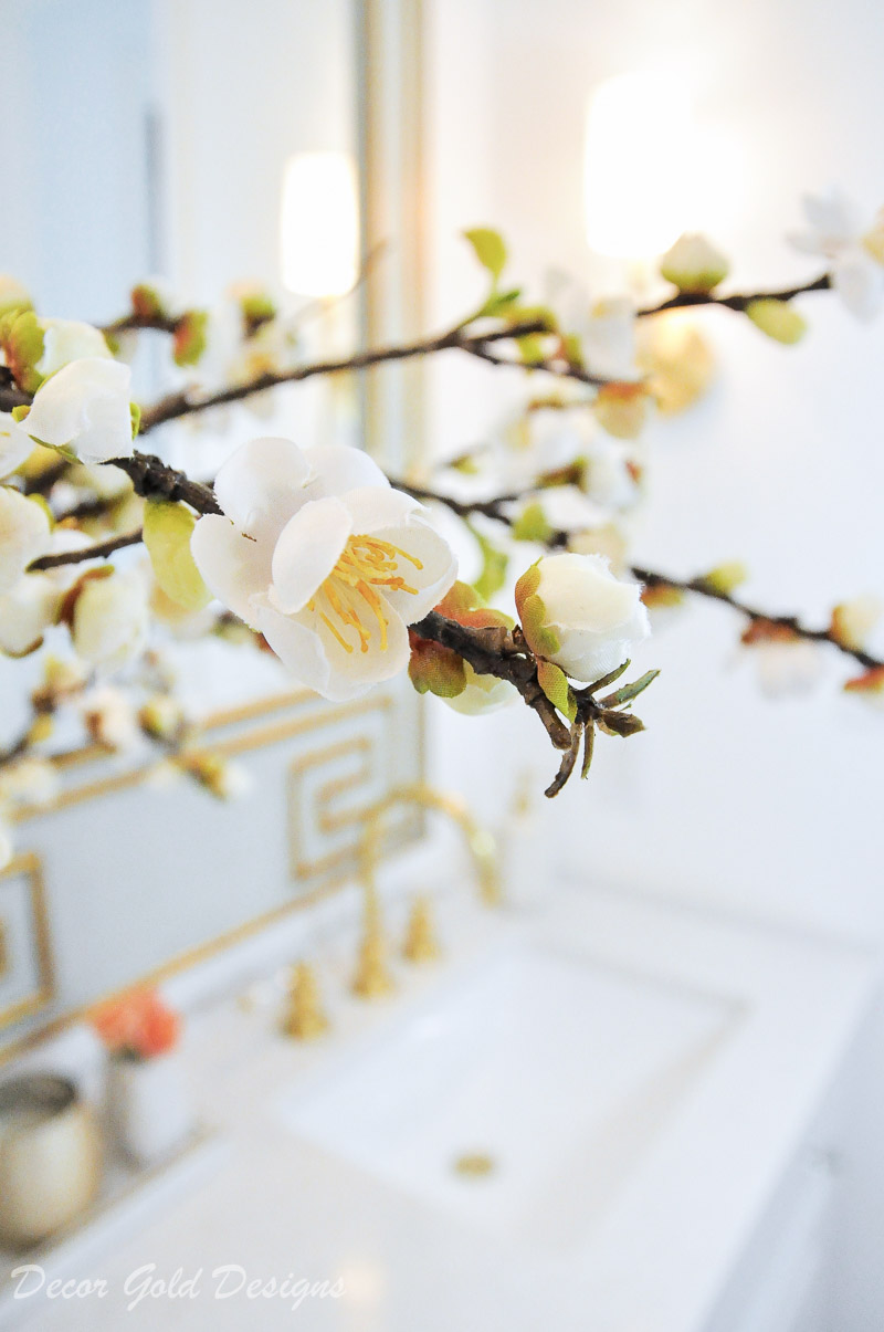 Powder bathroom preview through beautiful decorative floral branches