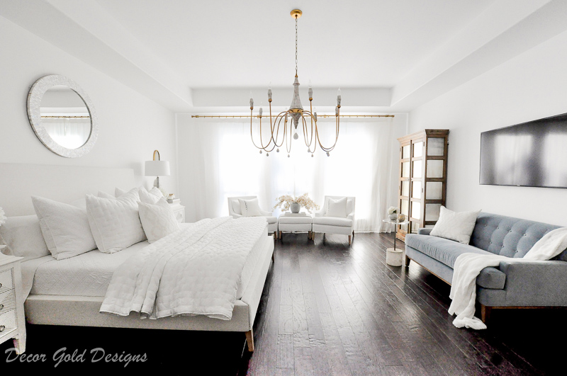 Master bedroom refresh white bed gold chandelier television blue sofa