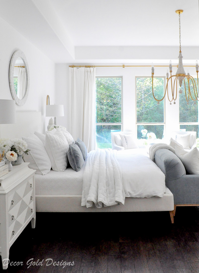 Master bedroom refresh white bed gold chandelier blue sofa