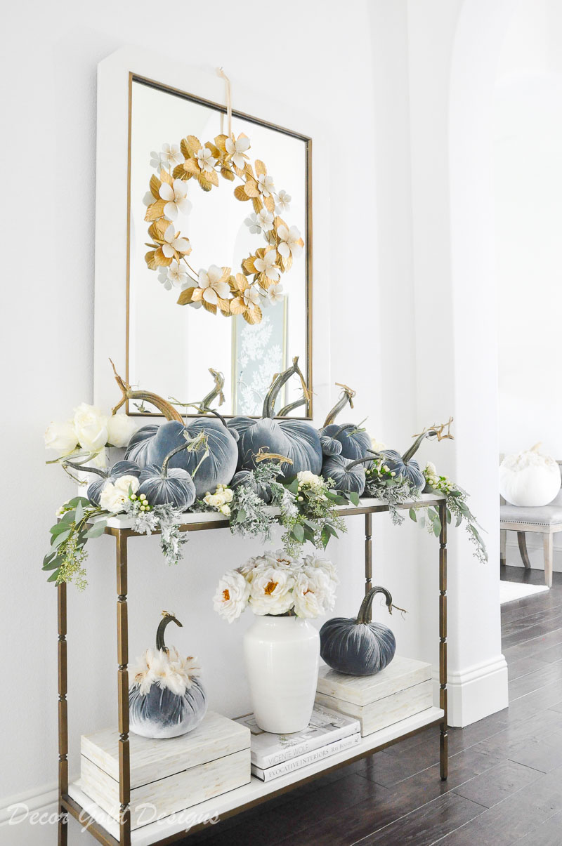 Beautiful pumpkin styling blue velvet pumpkins white console table