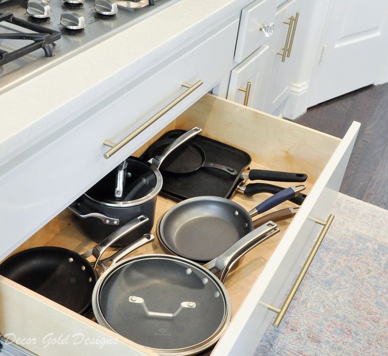 Kitchen organization project with a large drawer containing pots pans