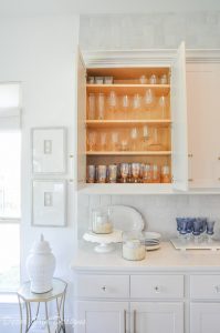 Kitchen organization project showing an upper cabinet glassware inside